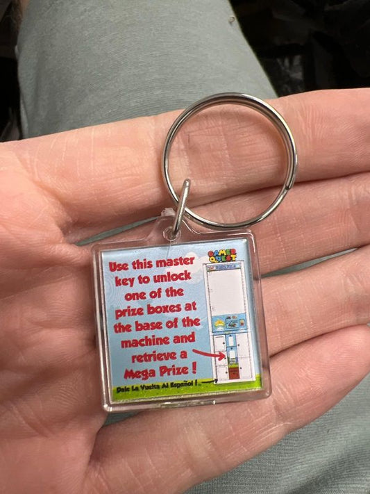 Instruction keychain for Claw Machine with prize box below